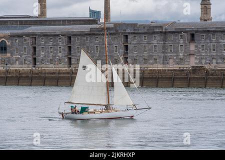 gaff rigged yacht sailing in harbour Stock Photo