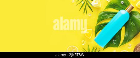 Blue shampoo bottle with combs, slices of citrus fruits, ice cubes and  exotic leaves on a yellow background with copy space. Hair care cosmetics  with Stock Photo - Alamy