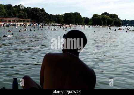 Berlin, Germany. 03rd Aug, 2022. A swimming supervisor observes bathing activities at the Wannsee lido. With temperatures around 33 degrees, many visitors are drawn to the outdoor pool. Credit: Carsten Koall/dpa/Alamy Live News Stock Photo