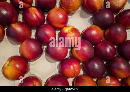 Nectarines in cassette for sale, top view of peaches Necatrines ripe Stock Photo