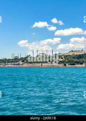 Historical view on Istanbul city on a sunny day with Ottoman Topkapi museum, Hagia Spohia church and Blue Mosque in background. Beautiful travel card Stock Photo