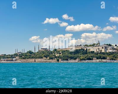 Historical view on Istanbul city on a sunny day with Ottoman Topkapi museum, Hagia Spohia church and Blue Mosque in background. Beautiful travel card Stock Photo