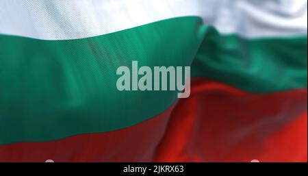 Close-up view of the Bulgarian national flag waving in the wind. Bulgaria is a country in Southeast Europe. Fabric textured background. Selective focu Stock Photo