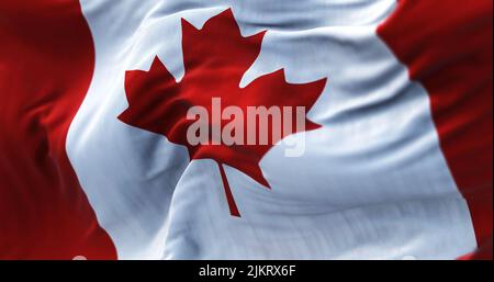 Close-up view of the canadian national flag waving in the wind. is a country in North America. Fabric textured background. Selective focus Stock Photo