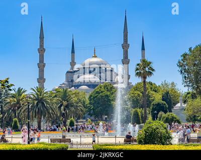 Istanbul, Turkey - July 14, 2022:  Gorgeous Sultan Ahmed Mosque, known as the famous Blue Mosque in Istanbul. Fountain view. Tourist walking in park Stock Photo