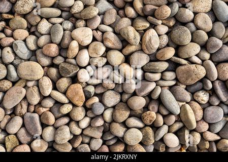 Abstract close up of multicoloured smooth round natural stones, pebbles.  Stock Photo
