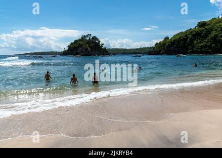 Nusa Penida, Indonesia - April 01, 2019: View of people enjoying sunny day and beach in Crystal beach. Crystal beach is a famous tourist location Nusa Stock Photo