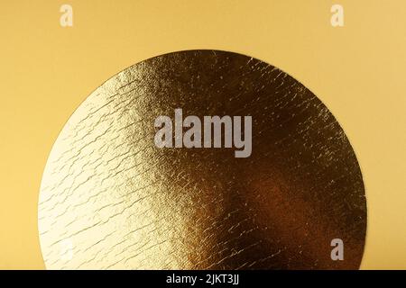 Golden circle on a yellow background. Stock Photo
