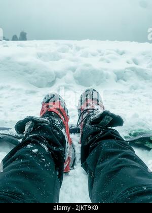 A vertical shot of winter shoes with spikes for trekking in Kedarkantha mountain Stock Photo