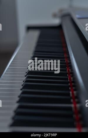 out-of-focus piano keys with shallow depth of field and red tones Stock Photo