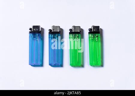 Four or two pairs of blue and green matchsticks posing like male and female human beings, isolated on a white background. Stock Photo