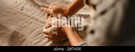 Young black ceramist woman wearing apron sculpting in clay at her workshop Stock Photo
