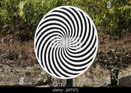 Optical illusion spiral wheel with a natural background Stock Photo