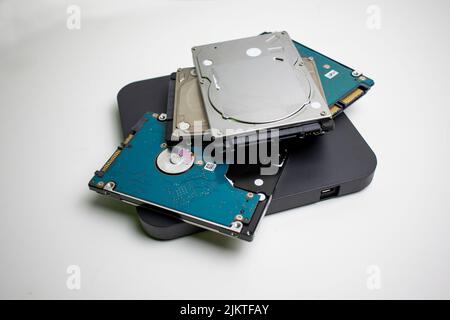 Stack of internal laptop hard drives in a pile on a white background Stock Photo