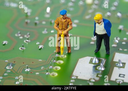 closeup of a team of technicians working on an electronic circuit board Stock Photo