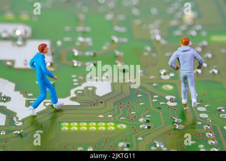 closeup on joggers running on an electronic circuit board , concept: cycle of health Stock Photo