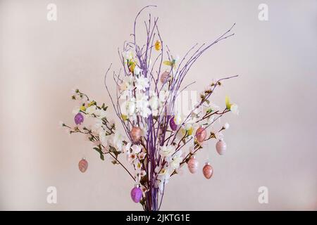 Branches with Easter decorations on a cloudy, uneven background Stock Photo
