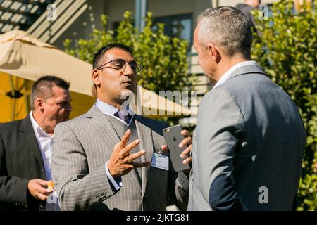 Two male delegates networking and discussing something at a business conference in Johannesburg Stock Photo