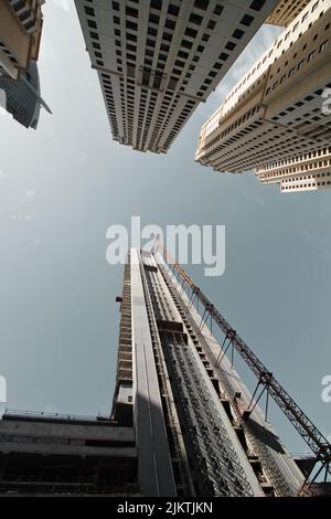 A low-angle shot of Dubai skyscrapers - high altitude building crane construction Stock Photo