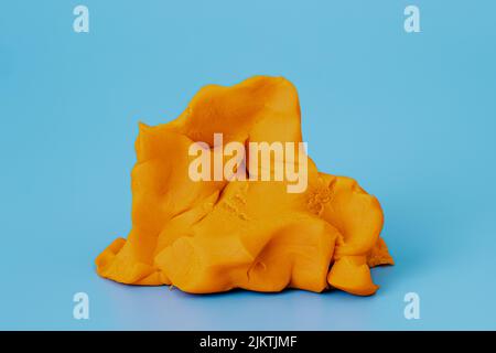 Play dough clay or colorful plasticine on blue background in studio. Preschool activities and creativity education Stock Photo