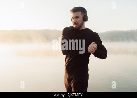 Man with headphones listening to music and doing sport. Stock Photo