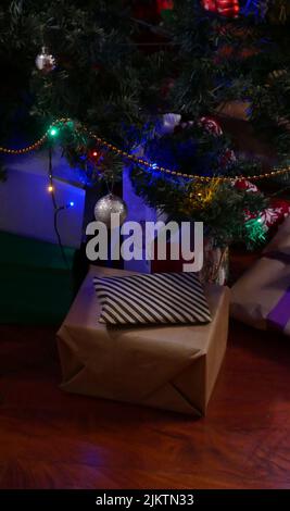 A vertical shot of gift boxes under the Christmas tree Stock Photo