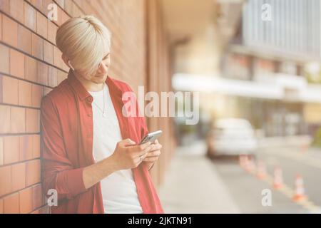 Young guy looking at his smart phone. Stock Photo