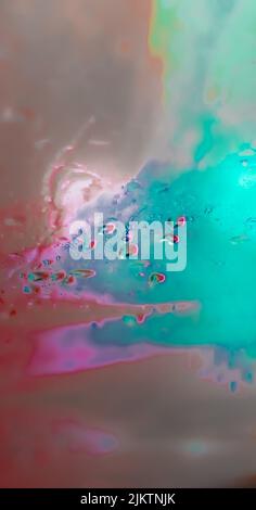 A vertical abstract glass texture with pink an blue paints on the wet glass Stock Photo