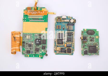 A closeup of a mobile phone mainboard components containing gold Stock Photo