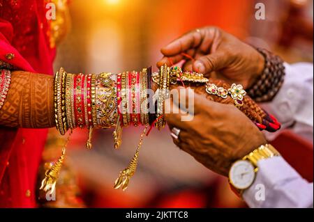 A Closeup of hands with henna tattoos during an Indian traditional wedding ceremony, kanyadan ritual Stock Photo