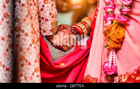 A Closeup of hands with henna tattoos during an Indian traditional wedding ceremony, kanyadan ritual Stock Photo