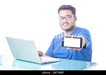 blurred man showing blank mobile phone screen with smile expression Stock Photo