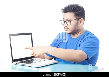 young student showing laptop screen and pointing finger Stock Photo
