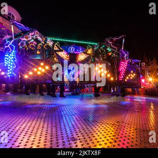 Teenagers sat with legs dangling waiting to start the 'Bodycount' ride ...