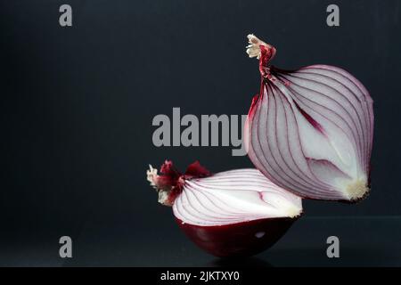 The Red onion and half slice on black background Stock Photo