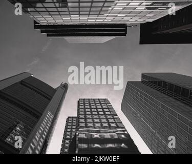 A low angle shot of modern skyscrapers in grayscale Stock Photo