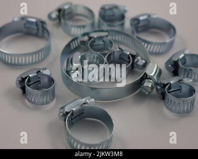 A selective focus shot of round clamps on a white surface Stock Photo
