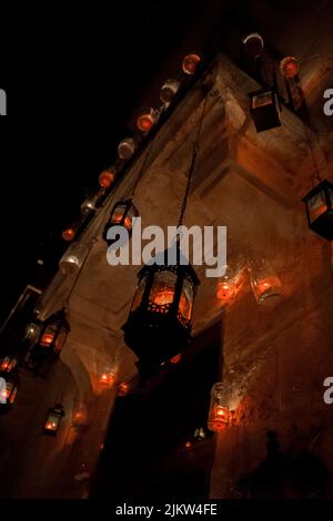 The facade of an old house in the harbour town of Birgu, Malta, decorated with a lot of lanterns and lit up with red candles for a local festival. Stock Photo