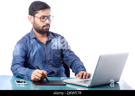 young graphic designer using stylus pen and digital tablet for drawing and editing in white background Stock Photo