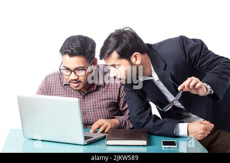 astonished boss and his employee surprised by looking at laptop screen Stock Photo