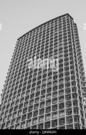 A vertical grayscale low angle shot of a tall modern building in London, UK Stock Photo