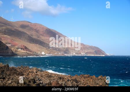 Beautiful volcanic coast with blue sea on volcanic island El Hierro, view of the village Puerto de la Estaca. Travel on the Canary Islands, Spain. Stock Photo