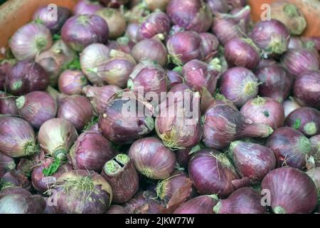 Red onion in market use for background. Fresh onion at the market. Red Onions Background Red Onions for Sale on Fresh Fruit Stall in Thai Fresh Market Stock Photo