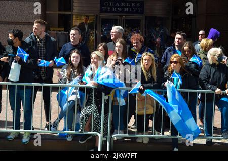 People are seen holding Scottish flag during the world's largest pipe and drum parade to celebrate Scottish Tartan Day on April 9, 2022 in New York Ci Stock Photo