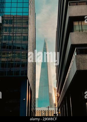 A vertical low-angle shot of skyscrapers on the sky background Stock Photo