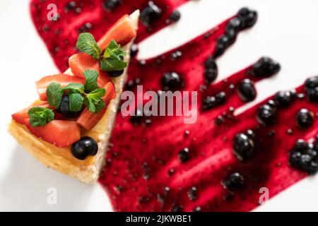 Top view of cheesecake with summer berries on dark background. Horizontal composition Stock Photo