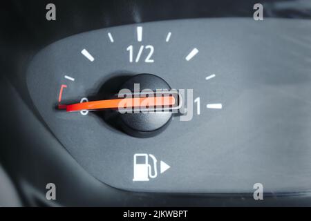 Close up of a fuel gauge showing an empty fuel tank in a car. Transportation with fossil fuel, high fuel and oil price. Stock Photo