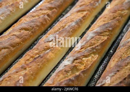 A closeup shot of a bunch of fresh baguettes in a market Stock Photo