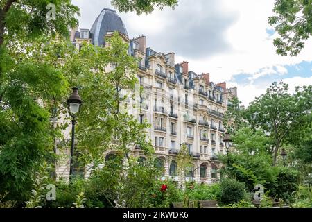 Paris, typical facade and windows, beautiful building boulevard Richard-Lenoir, with a public park Stock Photo