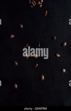 A beautiful shot of falling coffee beans isolated on black background Stock Photo